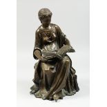 A CLASSICAL BRONZE SEATED FIGURE reading a book, 10 ins high.