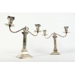 A PAIR OF CORINTHIAN COLUMN TWO BRANCH CANDLESTICKS on a square base 11.5ins high