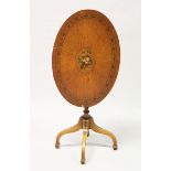 A SHERATON REVIVAL PAINTED SATINWOOD OVAL TILT TOP TRIPOD TABLE. 2 ft 3 ins wide x 2 ft 4 ins high.