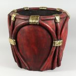 A COMPOSITION RED AND GILT JARDINIERE, 17 ins diameter.