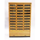 A GOOD HABERDASHERY CABINET with ten rows of three drawers with metal handles, tambour to the