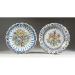 TWO POTTERY DISHES painted with flowers, 13 in. diameter.