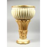 A COMPOSITION CREAM AND GILDED JARDINIERE on a circular base, 2 ft. high.