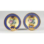 A PAIR OF ITALIAN CIRCULAR PORCELAIN ASHTRAYS, painted with roses, 8in. diameter