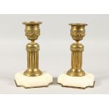 A SMALL PAIR OF ORMOLU AND MARBLE CANDLESTICKS. 5ins high.