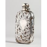 A GOOD GLASS AND PIERCED SILVER WHISKY FLASK with scrolled decoration, 5ins long.