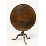 A GEORGE III MAHOGANY CIRCULAR TILT TOP TRIPOD TABLE, with dished top, turned vase shaped column
