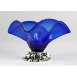 A BLUE LARGE GLASS SQUARED CENTREPIECE on a silvered base, 13 in.