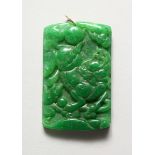 A CHINESE CARVED APPLE GREEN PENDANT 2.5 ins