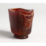 A SMALL HORN LIBATION CUP 1.75 ins high.