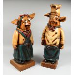 A PAIR OF AMUSING POTTERY PIGS, 24 in. and 21 in. high.