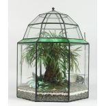 A TERRARIUM with plastic flowers 1 ft. 5 in. high