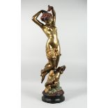 A TWO COLOUR GILDED BRONZE OF A STANDING NUDE with a cherub on a circular base, 3 ft. 3 in. high.