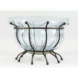 A TINTED SHAPED GLASS BOWL on a wrought iron stand, 13 ins diameter.