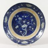 A CHINESE PRUNUS PATTERN BLUE AND WHITE DISH 11 ins diameter.