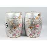 A PAIR OF CHINESE SILVER BARREL SEATS with peonies 17 ins high