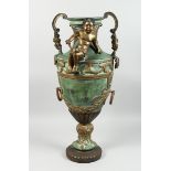 A BRONZE TWO HANDLED URN with cupid, acanthus scroll and laurel leaf handles, 2 ft. 8 in high.