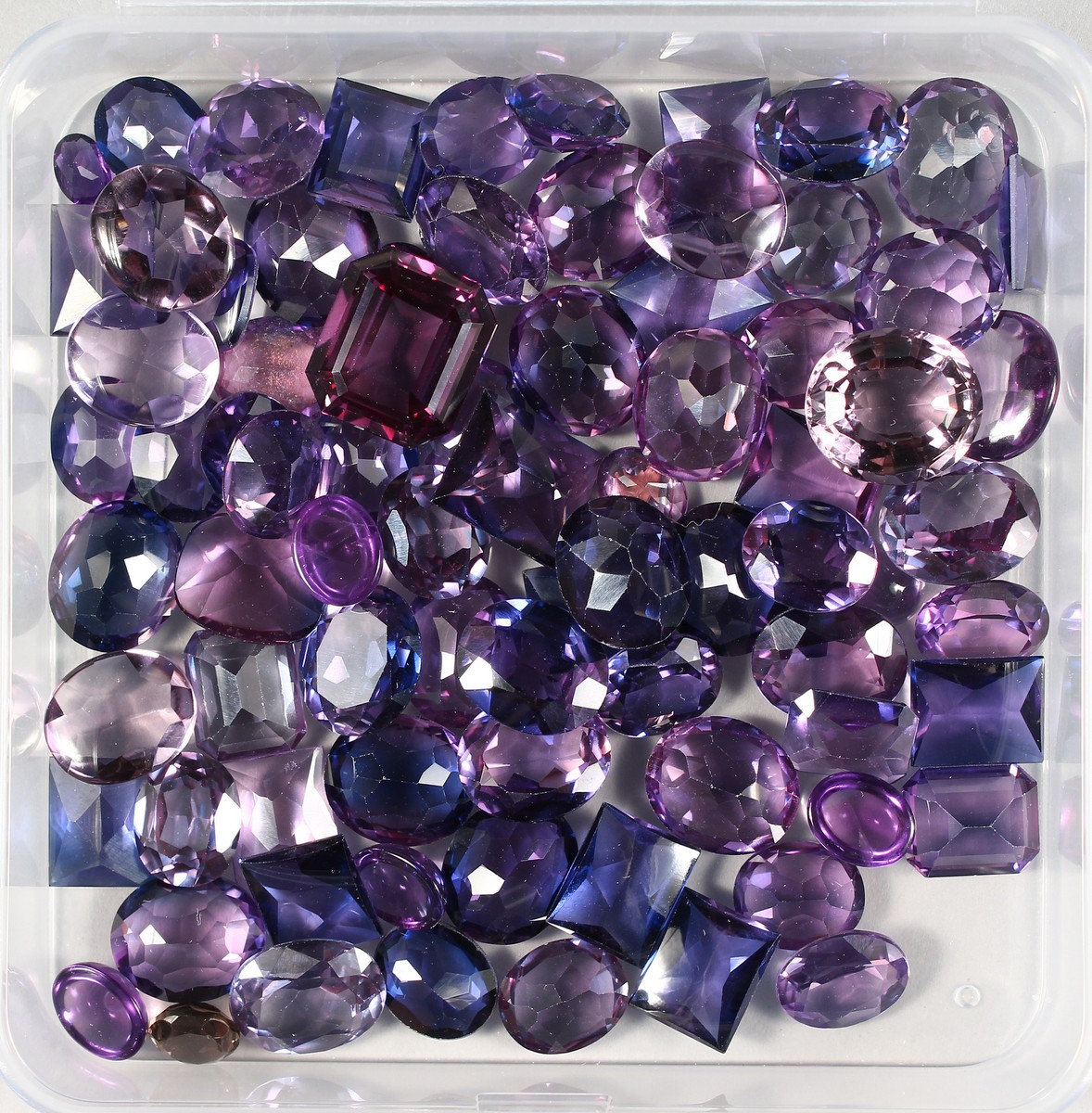 A BOX OF AMETHYST AND KUNSIT STONES