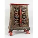 A CHINESE LACQUERED CABINET with mosaic inlaid doors and pierced decoration, 2 ft. 2in. high.