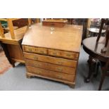 A George III oak bureau, the fitted interior having a small door with old paper label.