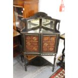 An Aesthetic movement ebonised and parcel gilded corner cabinet.