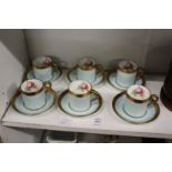 A set of six Paragon china coffee cans and saucers, pale blue ground with rose decorated interiors.