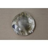 A heavy circular rock crystal pendant.