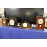 Two mantle clocks, a barometer and a desk calendar.
