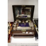 A Victorian walnut dressing table box containing cut glass jars with plated mounts.