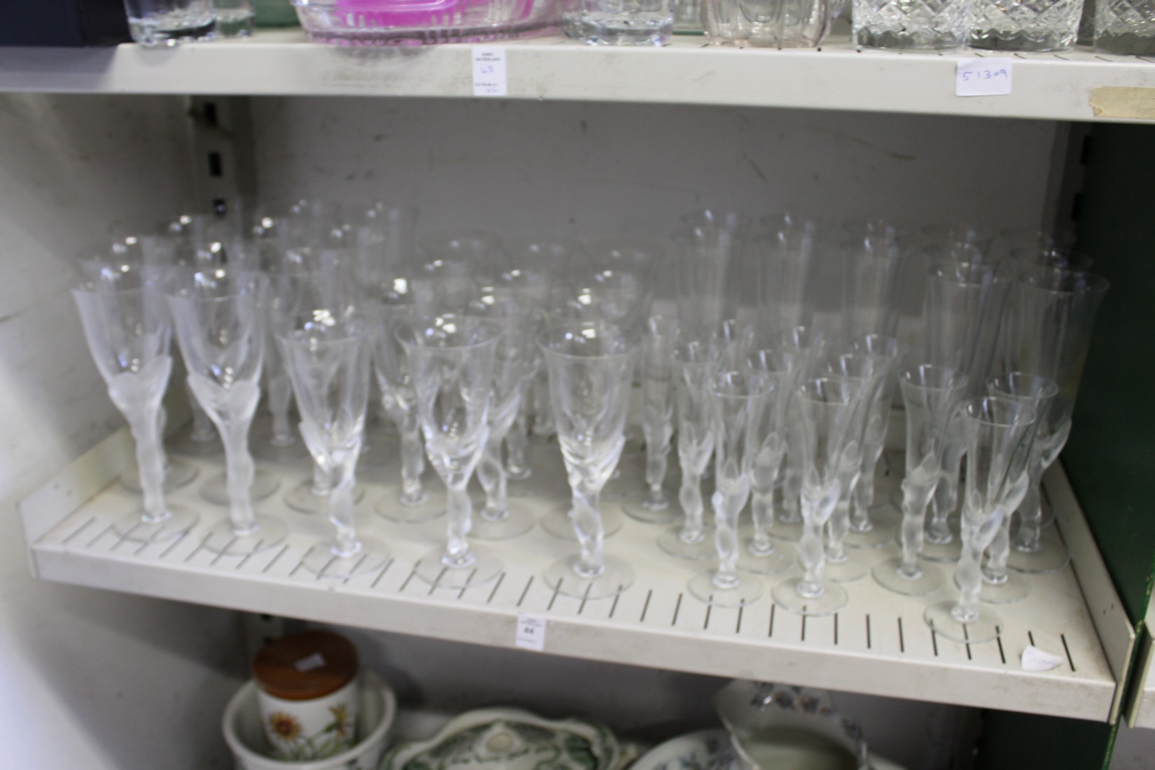 A suite of drinking glasses with frosted glass stems modelled as pairs of doves.