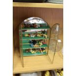 A miniature glass cabinet containing tiny Teddy bears.