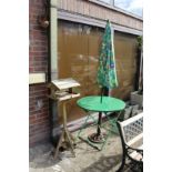 A bird table, a folding table and parasol.