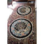 A pair of Chinese circular small rugs.