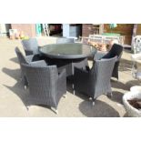 A good patio set comprising a large circular table and six armchairs, all with modern woven material