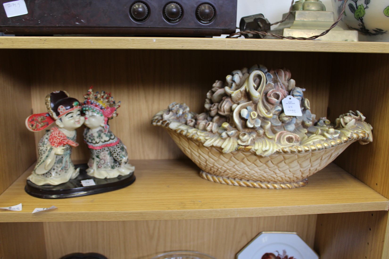 A model of two Chinese children and a moulded floral basket ornament.