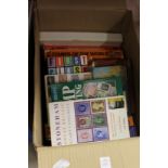 A box of stamp reference books.
