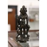 A small cast bronze deity.