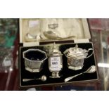 A cased silver three piece condiment set and various small items of flatware.