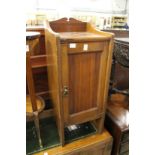 An Edwardian walnut pot cupboard.