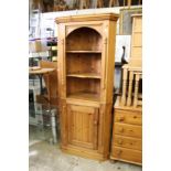 A pine corner cabinet.