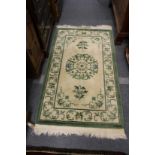 A pale cream and green Chinese rug.
