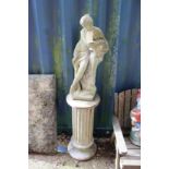 A garden figure of a classical female on a column support.