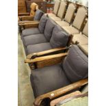 An oak framed Bergere three piece suite comprising three seater settee and a pair of armchairs.