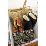 An evening bag, two pairs of boots and a wicker shopping basket.