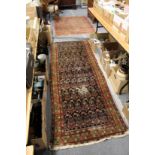 An old Persian runner and a small Persian rug (AF).