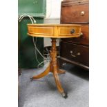 A yew wood small drum table.
