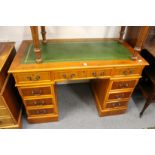 A reproduction yew wood pedestal desk.