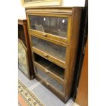 An oak Globe Wernicke style four section stacking bookcase (one section lacking glass).