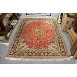 A good Persian, rug rust ground with floral decoration.