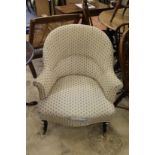 A late Victorian upholstered armchair.
